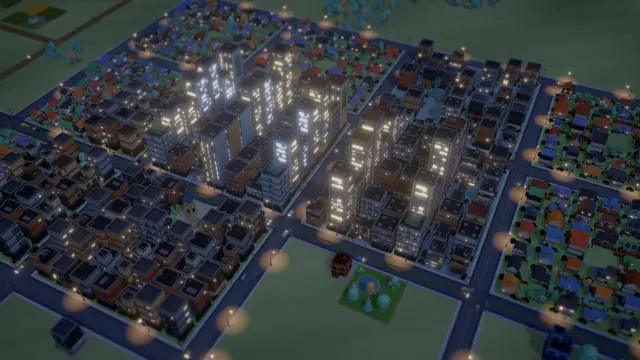 Downtown towers with lit windows and street lamps at night